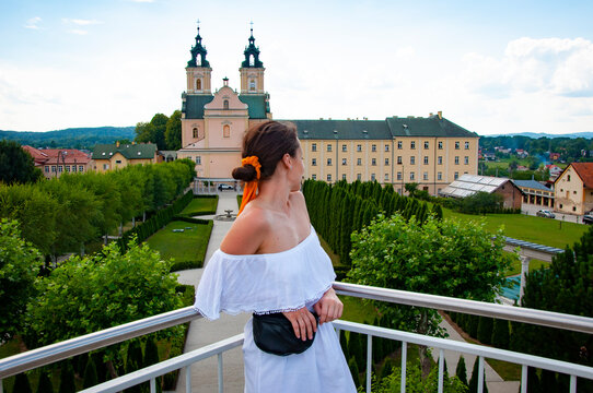 Woman in summer romantic dress at chapel castle travel destination. Summer castle and woman. Summer style
