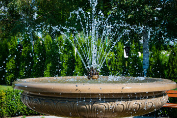 Fountain with water in the summer park. Summertime outdoor. Fountain architecture