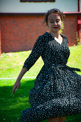 Romantic girl dance on lawn. Carefree woman in the summer park outdoor. Summer vacation and...