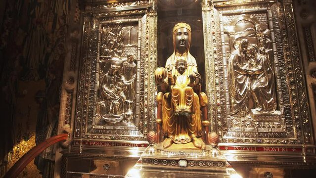 The carved sculpture of Madonna - Nuestra Senora de Montserrat in the chruch Iglesia de Belen. Black Madonna in Montserrat Monastery, Spain, Catalonia.