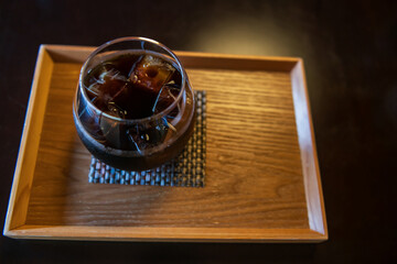 Ice Americano black coffee on wooden table by top view
