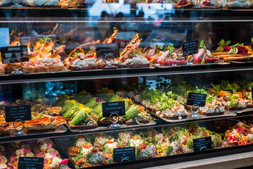 Selection of traditional open-faced sandwich in cuisines of Denmark (Smørrebrød), Norway (smørbrød) and Sweden (smörgås). Consists of buttered rye bread topped with meat or fish,  and salads. - obrazy, fototapety, plakaty