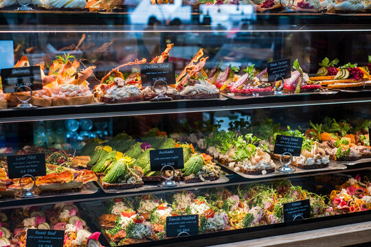 Selection of traditional open-faced sandwich in cuisines of Denmark (Sm&oslash;rrebr&oslash;d), Norway (sm&oslash;rbr&oslash;d) and Sweden (sm&ouml;rg&aring;s). Consists of buttered rye bread topped with meat or fish,  and salads.