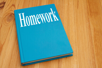 Homework for a course on retro old blue book on weathered desk - 784017611
