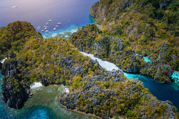 Aerial drone of entrance to big lagoon with limestone cliffs and blue water. Miniloc island, Marine National Reserve in El Nido, Palawan, Philippines