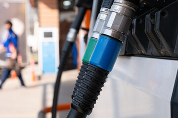 Close-up of fuel pump hosepipes at a gas station.