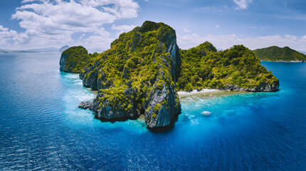 Aerial drone panorama view of tropical paradise island. Karst limestone rocky mountains surrounds...