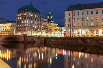 Fototapeta premium Historic buildings along Gothenburg city canal , night, water reflections. Concept of travel and urban serenity. Gothenburg, Sweden