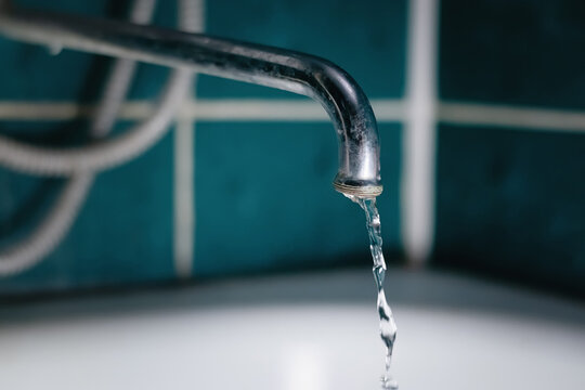 A small stream of water from the bathroom tap