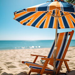 Sun lounger and striped beach umbrella, blurred background, close up, copy space