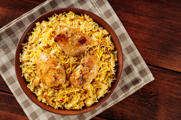 Pakistani and Indian Chicken Biryani Rice in Clay Bowl on Wooden Boards