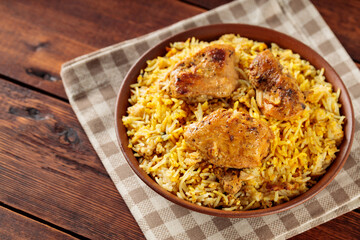Pakistani and Indian Chicken Biryani Rice in Clay Bowl on Wooden Boards
