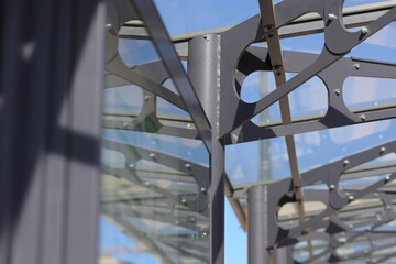 Metal structure of the bus stop and the blue sky