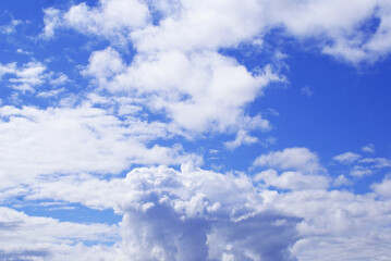 Naklejka na ściany i meble Blue sky with lush clouds, background. Design.