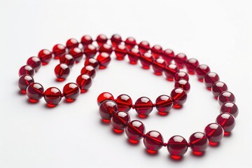 A simple red bead necklace on a clean white background. Perfect for jewelry or fashion concepts - obrazy, fototapety, plakaty