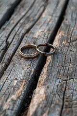Two wedding rings displayed on a rustic wooden table. Perfect for wedding themes and jewelry concepts