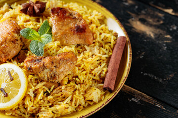 Hyderabadi Chicken Biryani on Rustic Table, Traditional Non-Vegetarian Food of India, Close-up