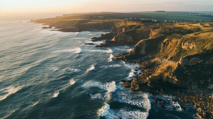 A serene sunset view overlooking a rugged cliff coastline with gentle waves brushing the shore