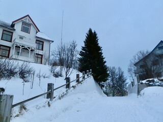 Deep snow blankets this road leading uphill to a residential community in Tromso in January.