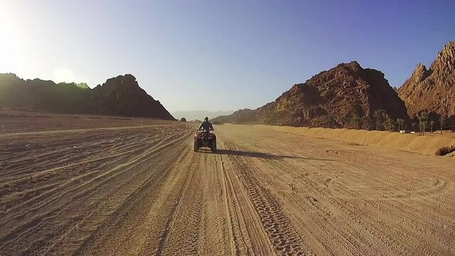 Driving ATVs in the Desert of Egypt. Riding on Quad Bikes in the Desert of Egypt. Adventures of desert off-road on ATVs. First-person view on action camera.