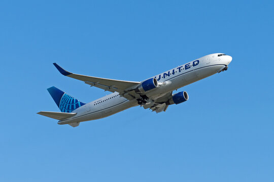 United Airlines Boeing 767-322 plane departing from London Heathrow Airport on a clear sunny day. London - 10th August 2023