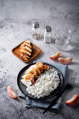 Roasted chicken breast slices with peach with rice in a plate - 784079265