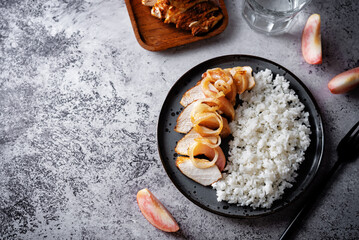 Roasted chicken breast slices with peach with rice in a plate