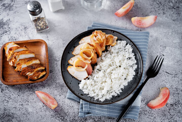 Roasted chicken breast slices with peach with rice in a plate - 784079281