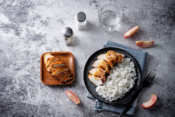 Roasted chicken breast slices with peach with rice in a plate - 784079297