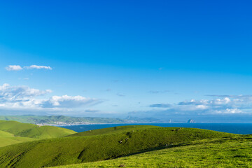 Green Fields of rolling hills and ocean