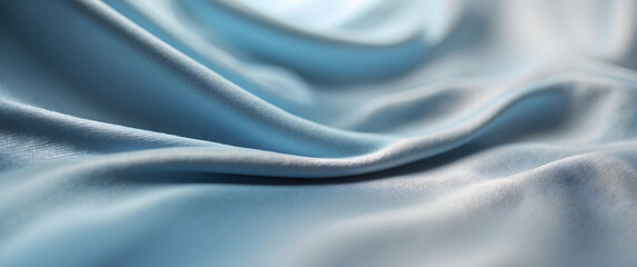 Obraz premium A high-resolution image capturing the delicate folds of a soft blue satin fabric, presenting an elegant and luxurious texture