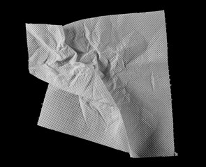 Crumpled and torn folded paper towel isolated on black