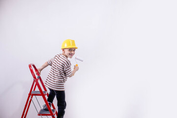 Boy painting wall during home renovation, copy space