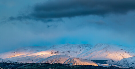 Panoramic view of Sierra Nevada (Granada, Spain) at sunset after a heavy snowfall in spring