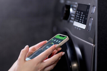 Smartphone with app used to control washing machines