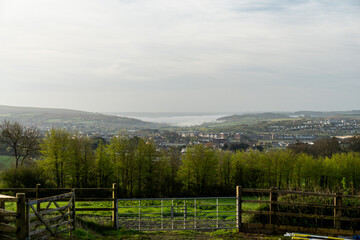 Obraz premium Serene early morning view of a valley town shrouded in mist with lush greenery