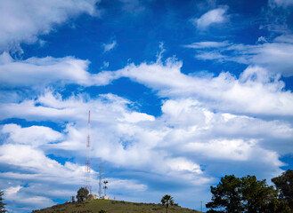 Clouds over antennas on hill, towers