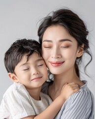 Asian mother hugging her child on background