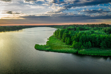 Boat on lake at sunset. Aerial view of nature, Poland.