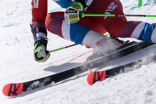 Crop close-up view of mountain skier skiing down an alpine mount ski slope. Russian Alpine Skiing Cup, International Ski Federation Championship, giant slalom. Kamchatka, Russia - April 1, 2019