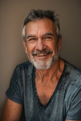Obraz premium Portrait of a happy senior man with a warm smile and casual style