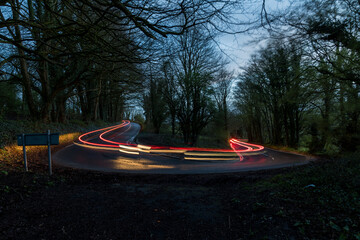 Nighttime long exposure of winding road with light trails