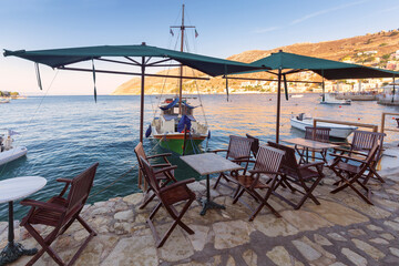 Street cafe above the sea on the embankment of the village Symi.