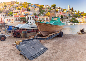Fishing boats in the village of Symi at sunset. - 784141452