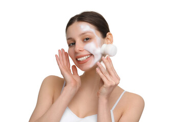 Young woman washing face with brush and cleansing foam on white background - obrazy, fototapety, plakaty