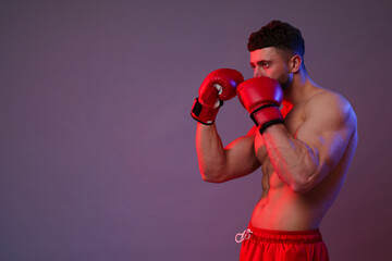 Man in boxing gloves on color background. Space for text