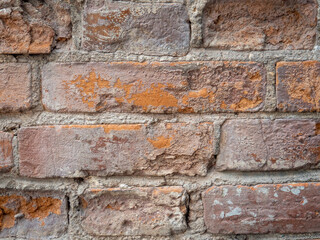 Red old brickwork. Chipped brick. Background from building materials.