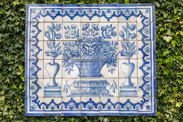 Traditional Blue and White Portuguese azulejos Tiles in a Flower Vase Design Mounted on a Garden Wall 