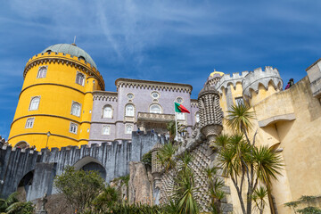 Looking up at the Golden Yellow Tower and Terraces at Peña Palace, Sintra, Portugal on a Blue Sky Spring Day - 784157403