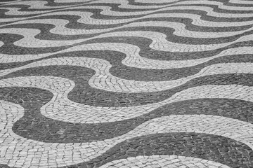 Undulating Waves of Black and White Stone of the Sidewalks of Portugal  - 784157666